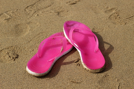 Pink flip flop on the beach