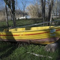 Yellow boat ashore on grass